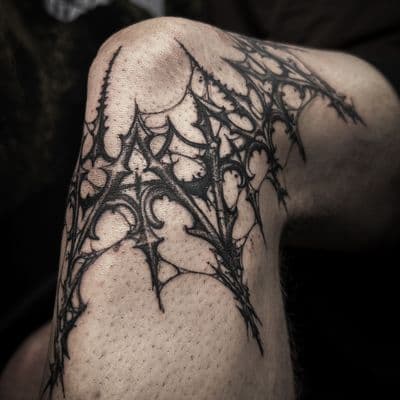 Gothic web pattern on knee
